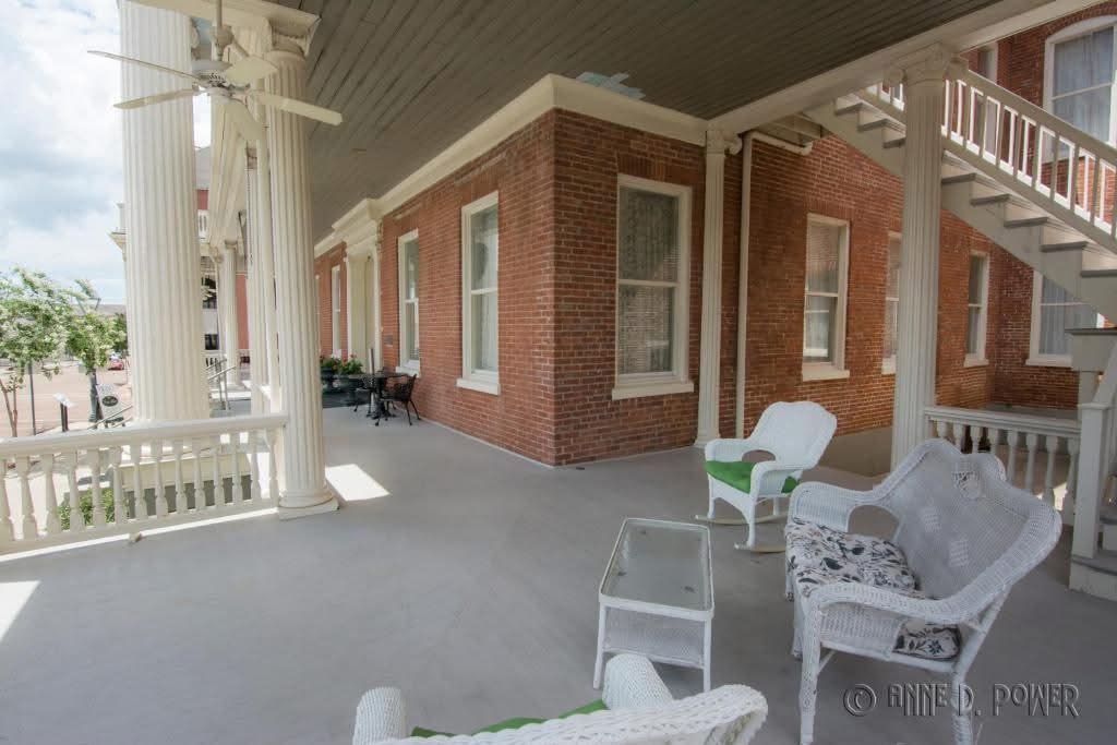 White wicker chairs on the veranda of The Guest House.